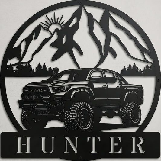 Custom black laser-cut metal offroad Toyota truck wall sign featuring lifted Tacoma 4Runner design with mountain pine tree silhouette and personalized name cut-out
